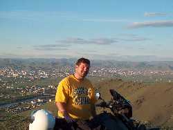 Scott stands with his BMW R100 GS with Ulan Bator as his back drop